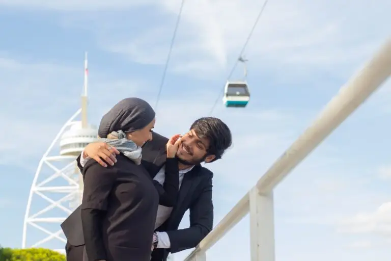 carefree-arabic-couple-walking-together-woman-with-covered-head-bright-make-up-smiling-touching-mans-cheek-love-affection-concept-min-scaled-1