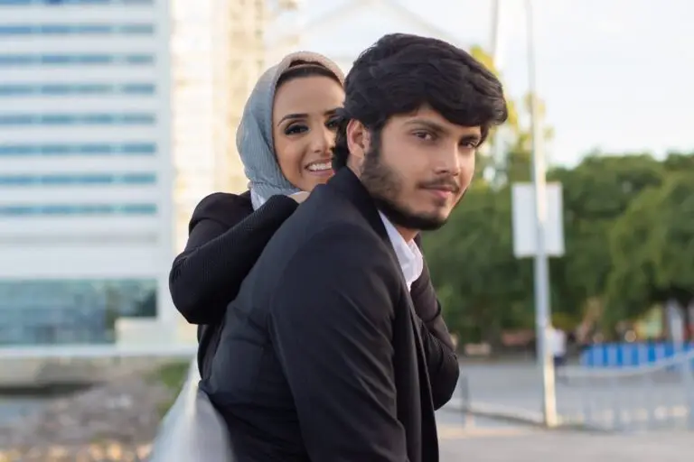 warm-arabic-couple-spending-time-together-woman-with-covered-head-bright-make-up-man-suit-sitting-bench-love-affection-concept-min-scaled-1